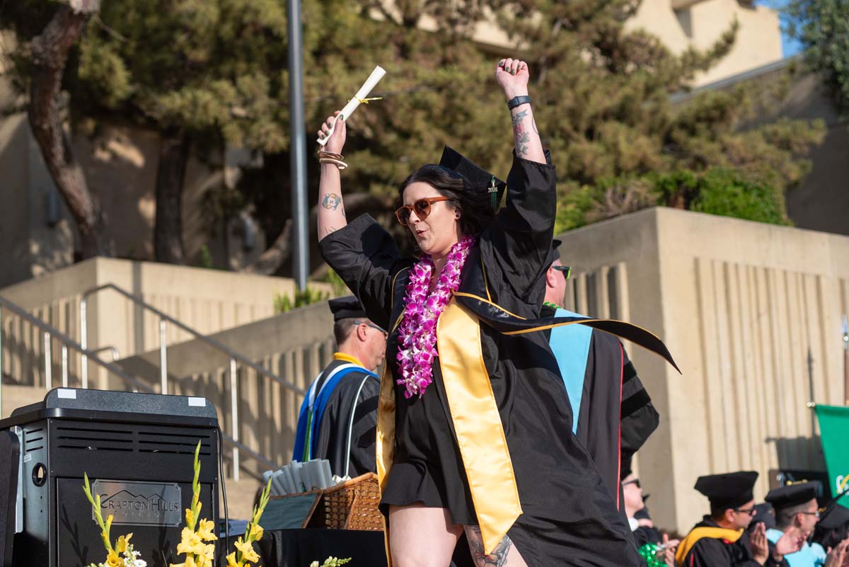 Graduates walk across stage at CHC Commencement 2024.