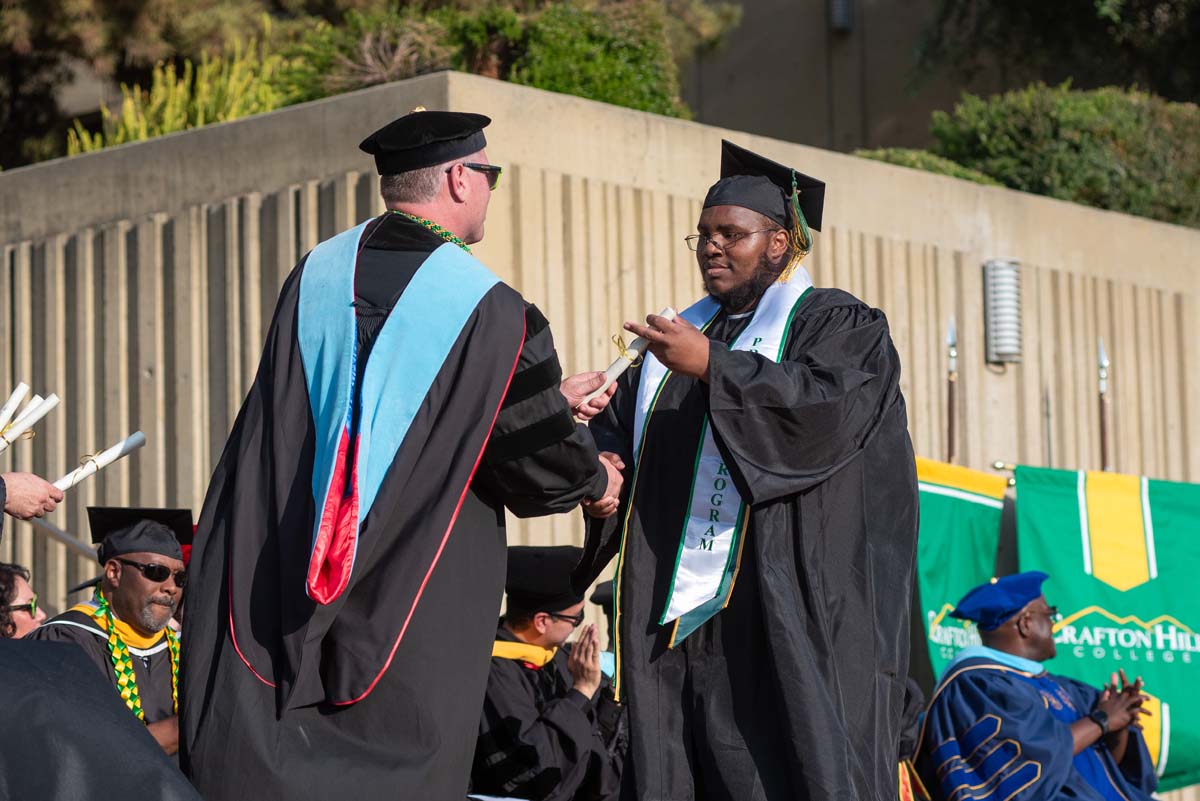 Graduates walk across stage at CHC Commencement 2024.