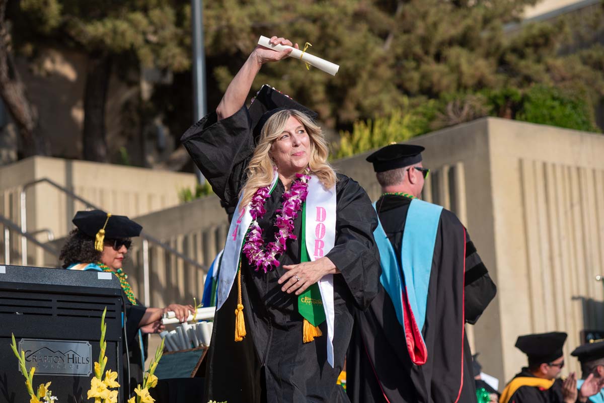 Graduates walk across stage at CHC Commencement 2024.