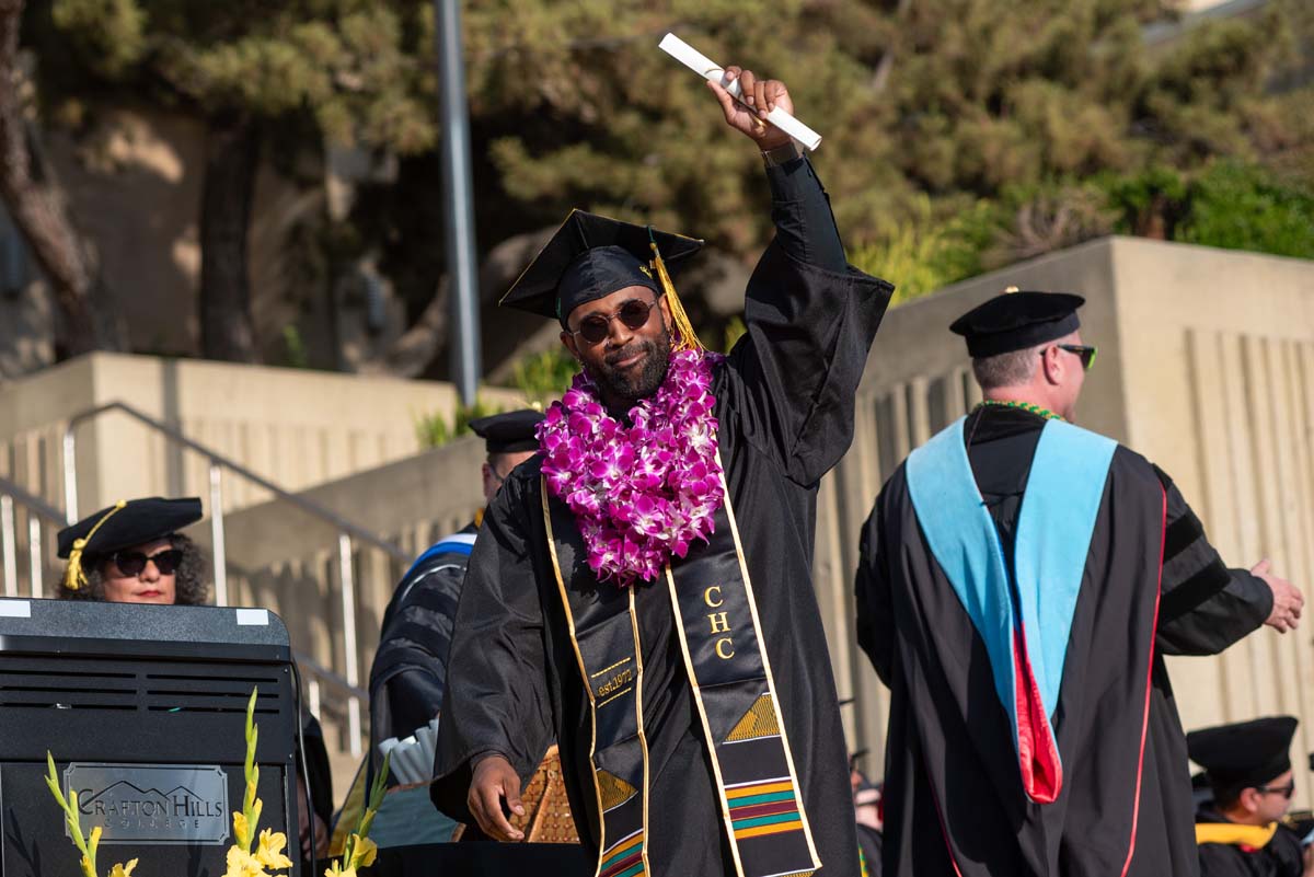 Graduates walk across stage at CHC Commencement 2024.