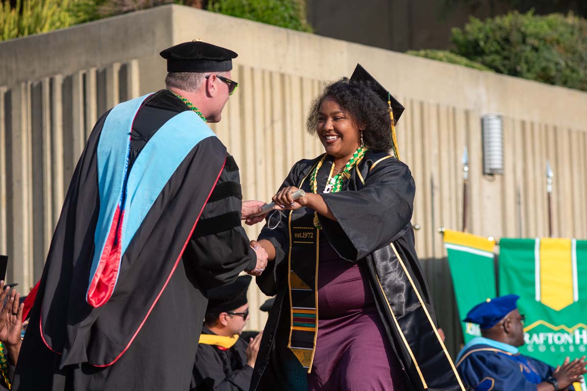 Graduates walk across stage at CHC Commencement 2024.