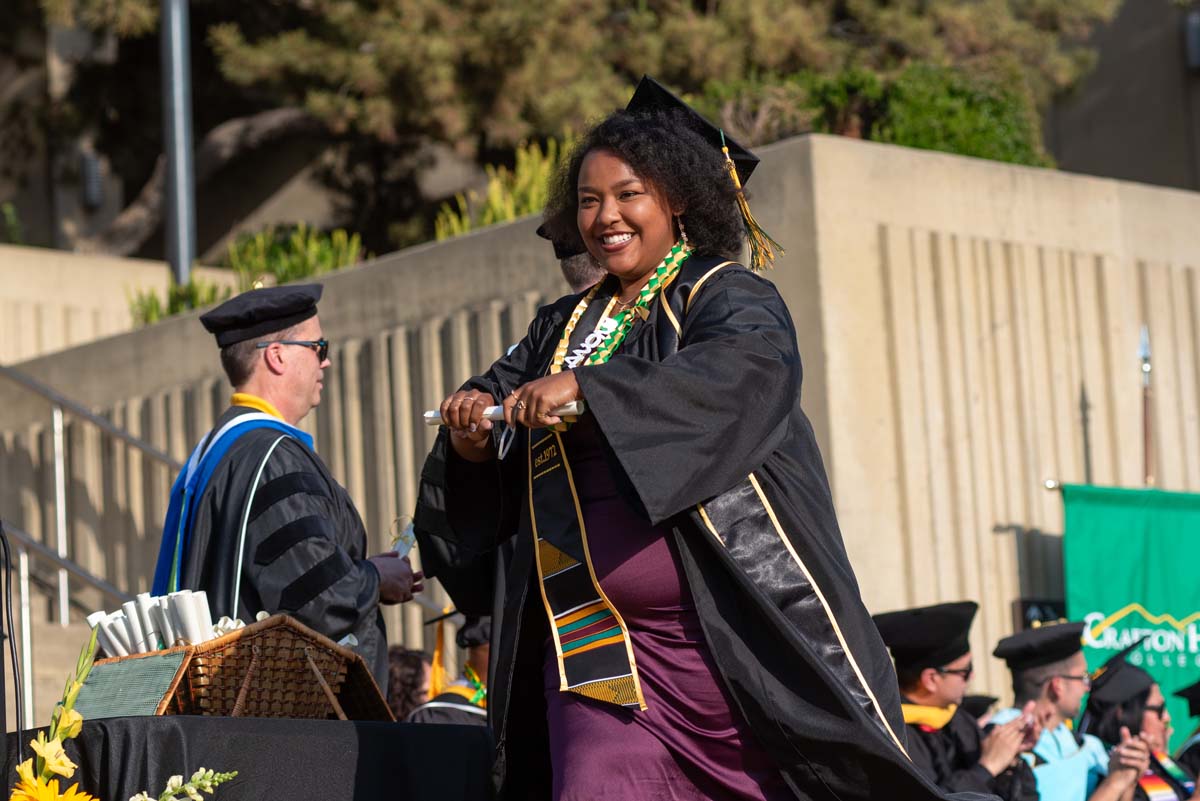 Graduates walk across stage at CHC Commencement 2024.