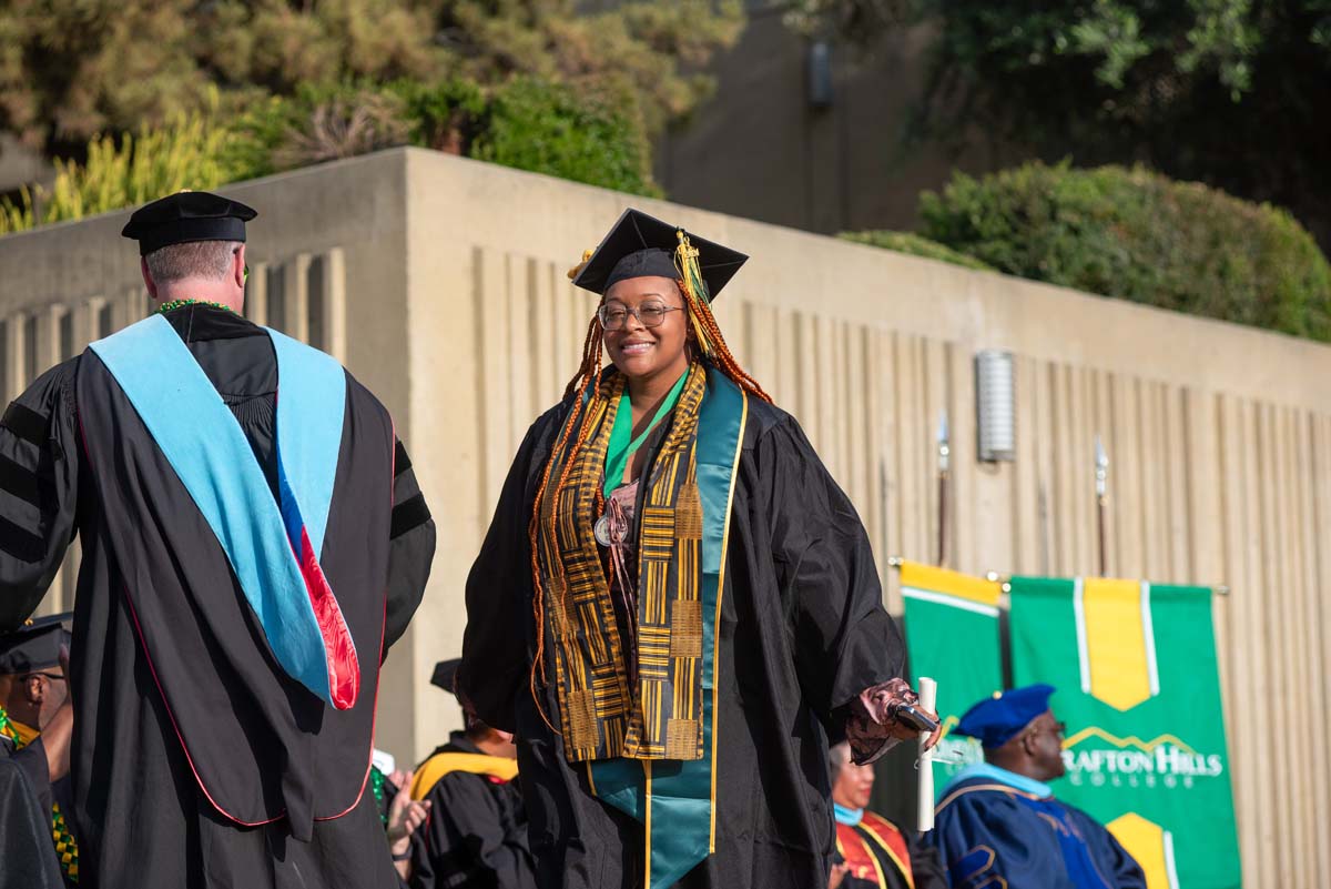 Graduates walk across stage at CHC Commencement 2024.