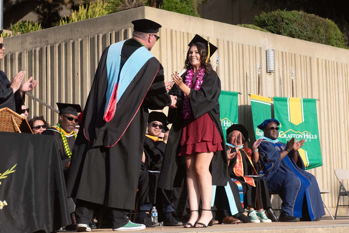 Graduates walk across stage at CHC Commencement 2024.