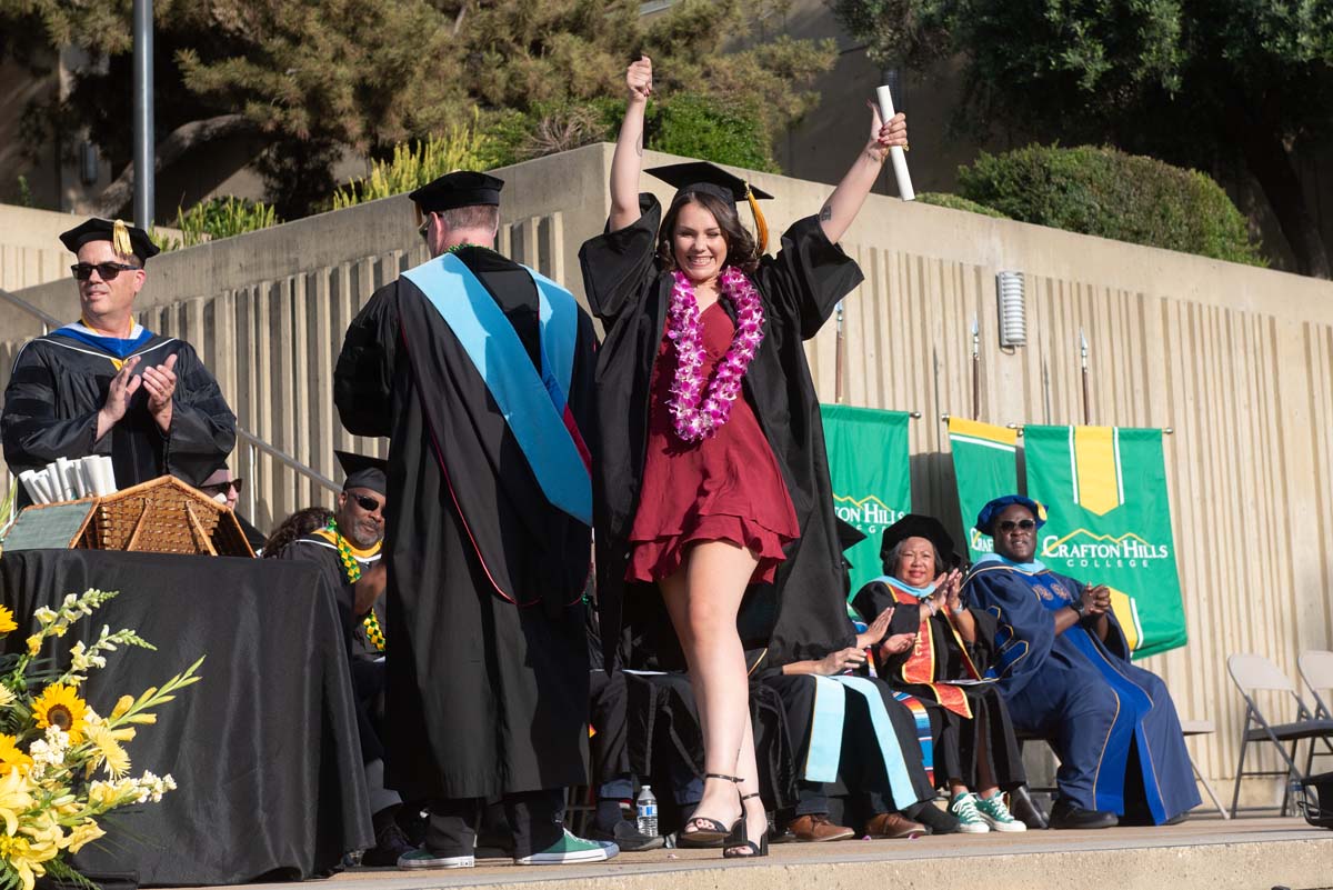 Graduates walk across stage at CHC Commencement 2024.