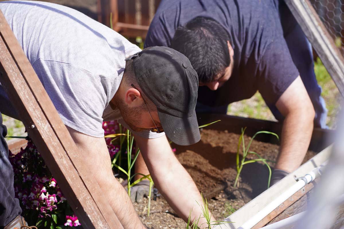 Students attend the planting party at the CHC garden.