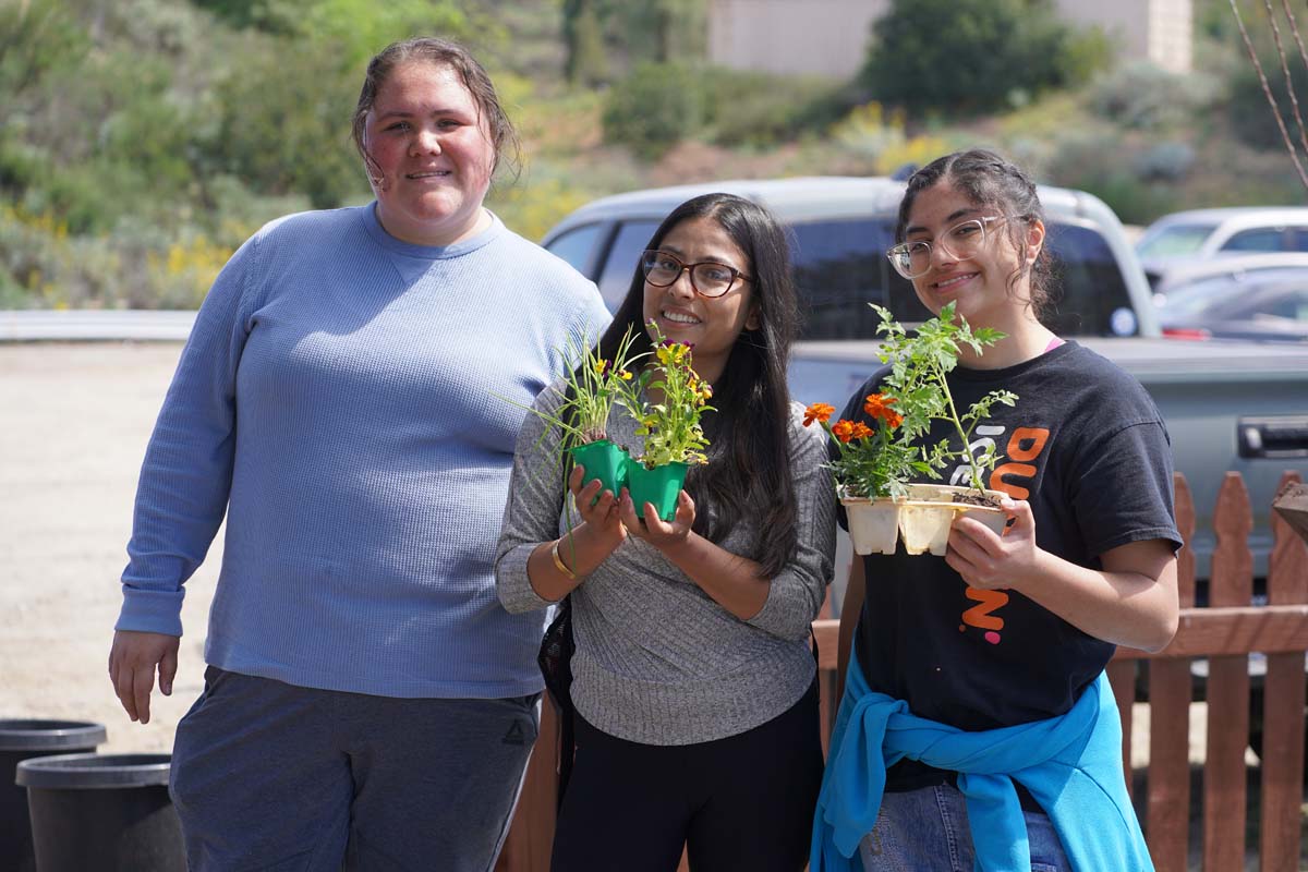 Students attend the planting party at the CHC garden.