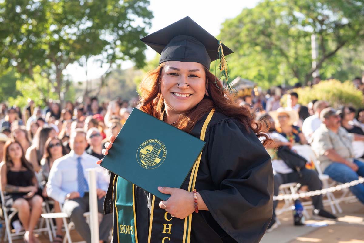 Students receive diploma covers at CHC Commencement 2025.
