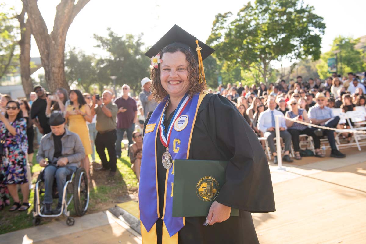 Students receive diploma covers at CHC Commencement 2025.