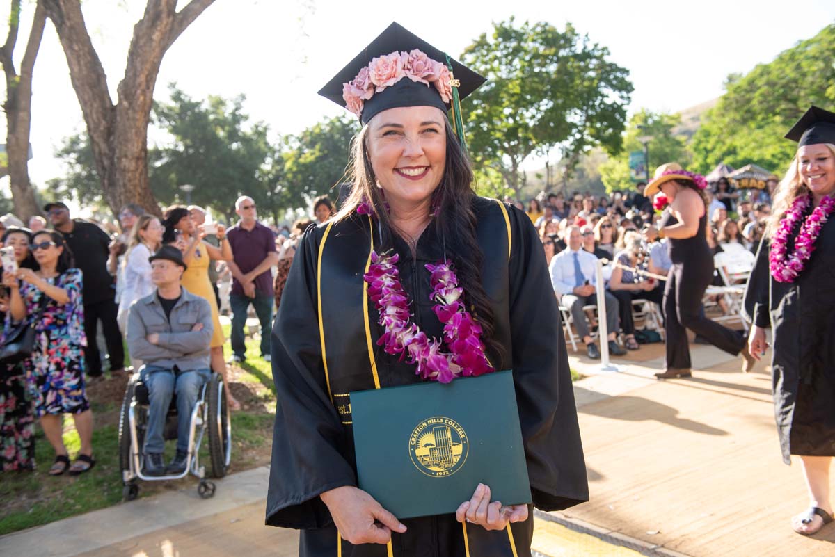 Students receive diploma covers at CHC Commencement 2025.