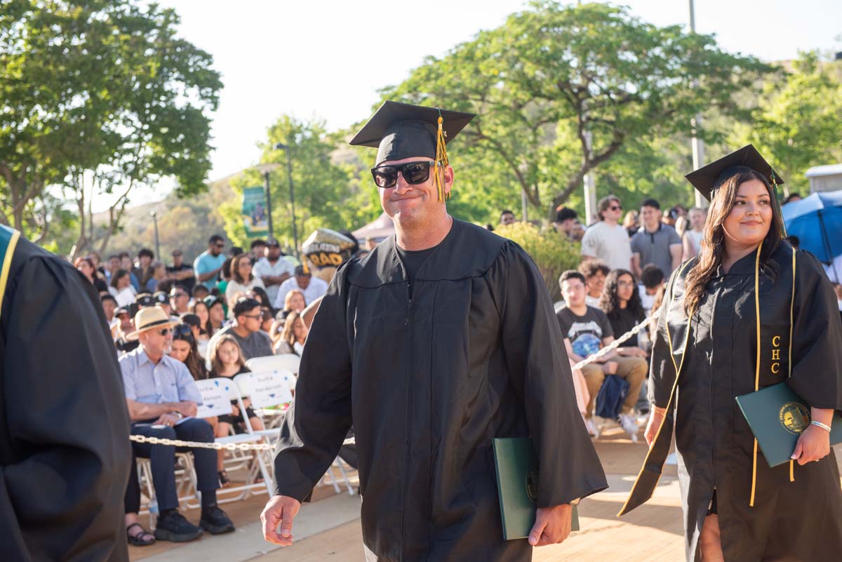 Students receive diploma covers at CHC Commencement 2025.
