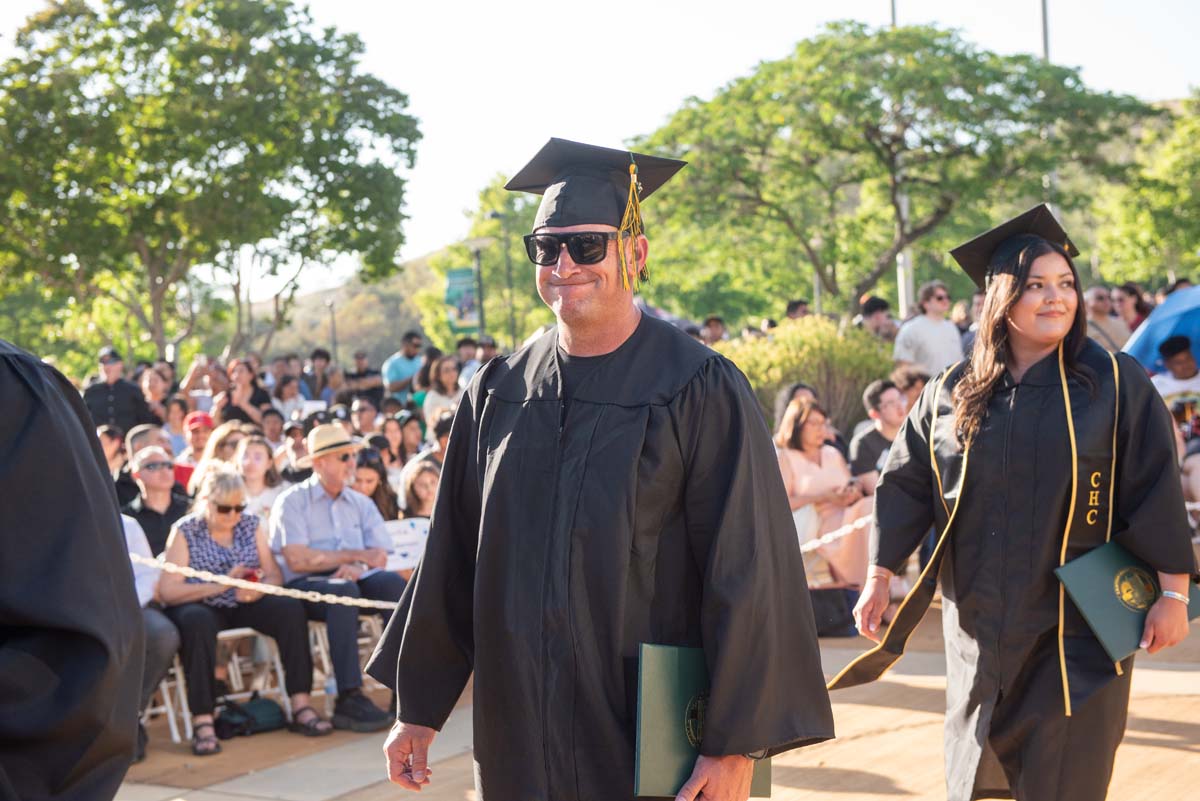 Students receive diploma covers at CHC Commencement 2025.