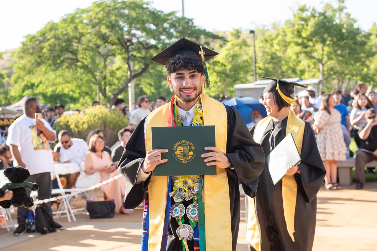 Students receive diploma covers at CHC Commencement 2025.