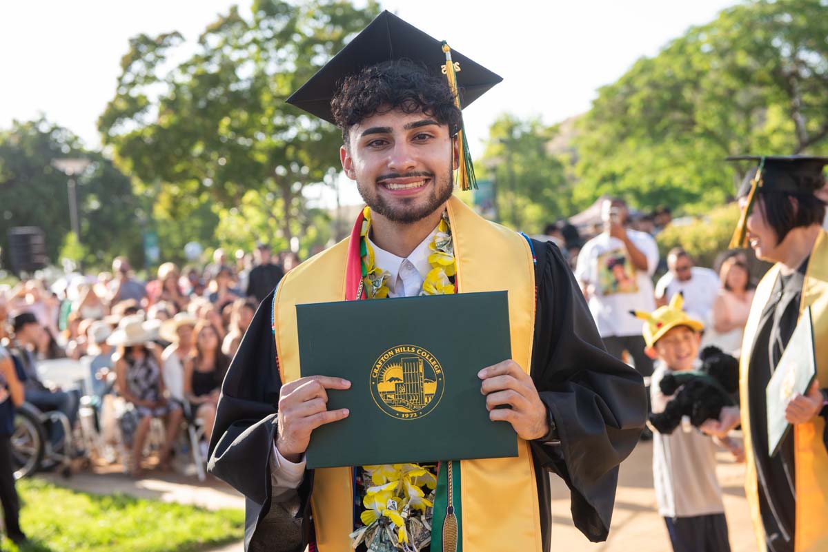 Students receive diploma covers at CHC Commencement 2025.