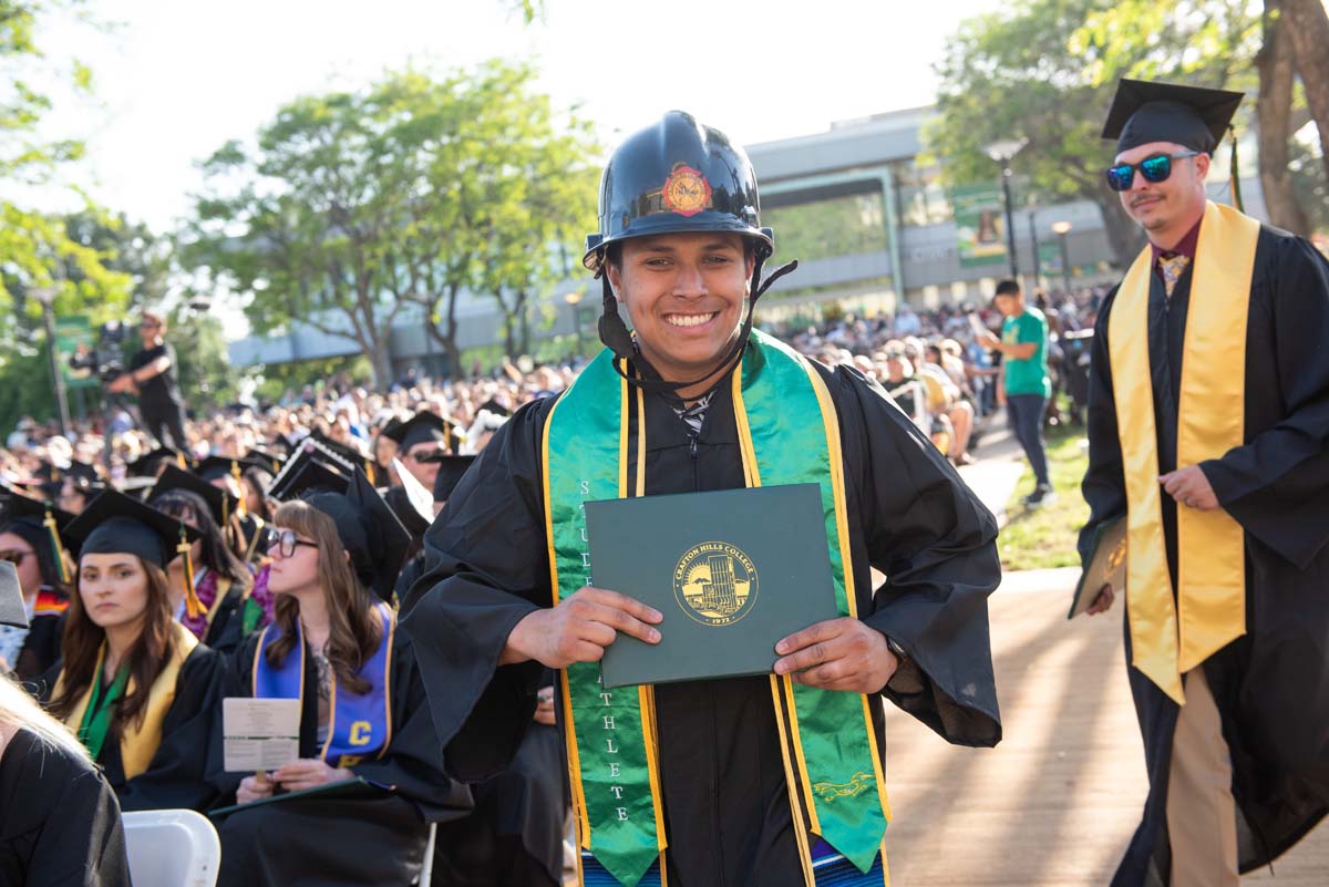 Students receive diploma covers at CHC Commencement 2025.