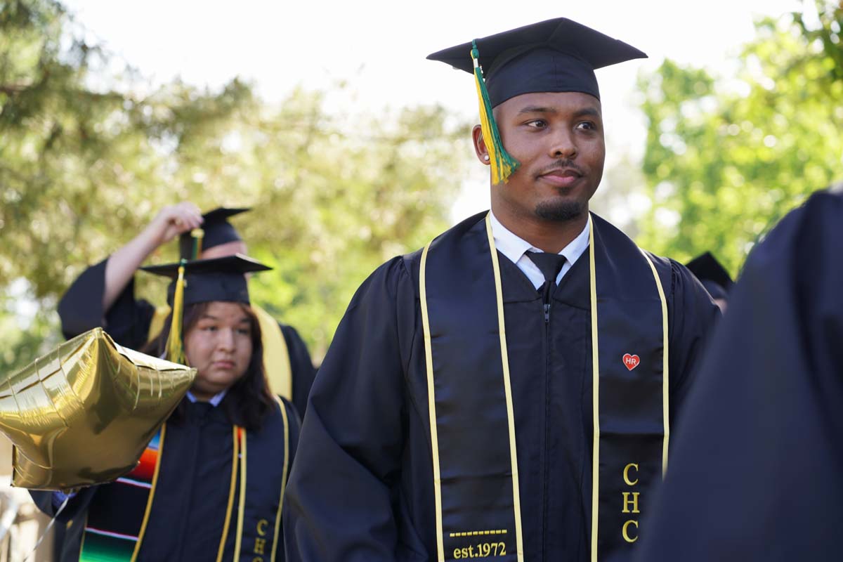 Students receive diploma covers at CHC Commencement 2025.