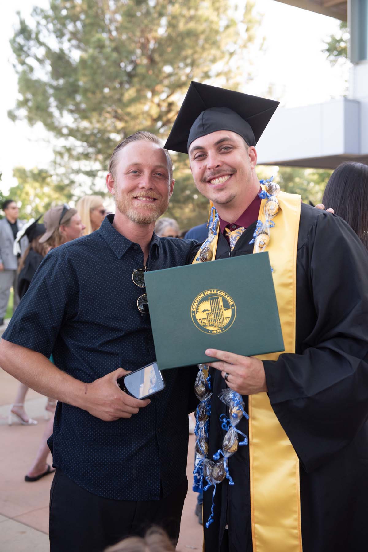 Grad recession at Commencement 2025 and pictures with family members.