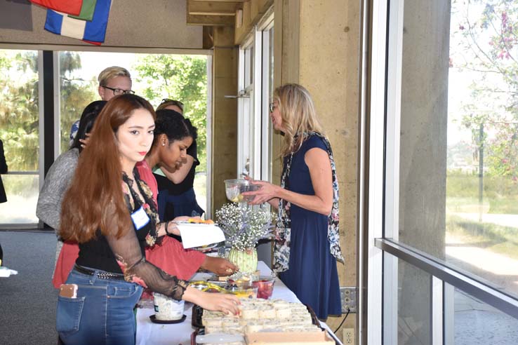 Students and faculty attend the spring Tea with the Deans event.