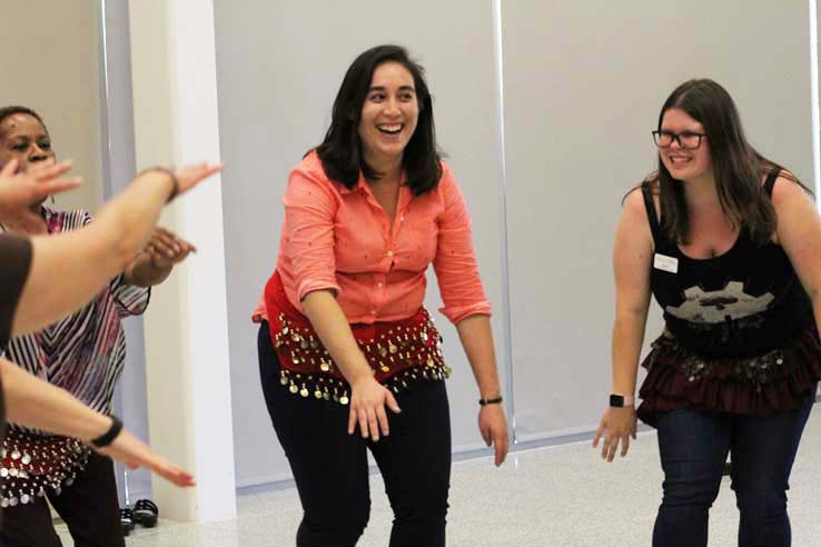 Staff practicing belly dancing