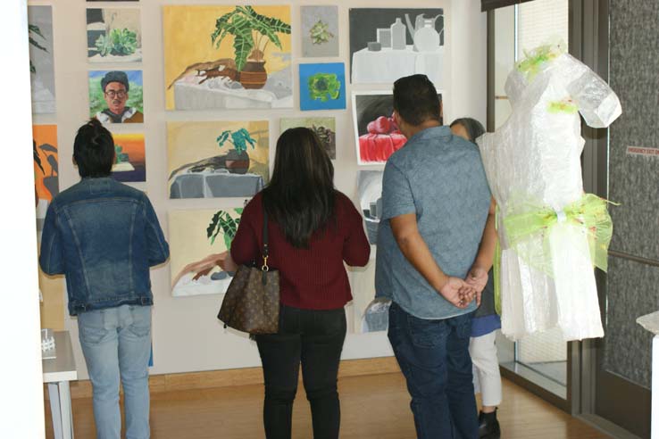 People enjoying the Student Art Exhibit