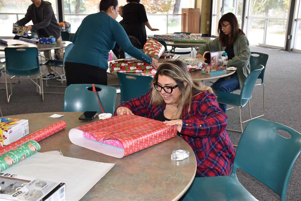 People enjoying the Holiday Wrap Party