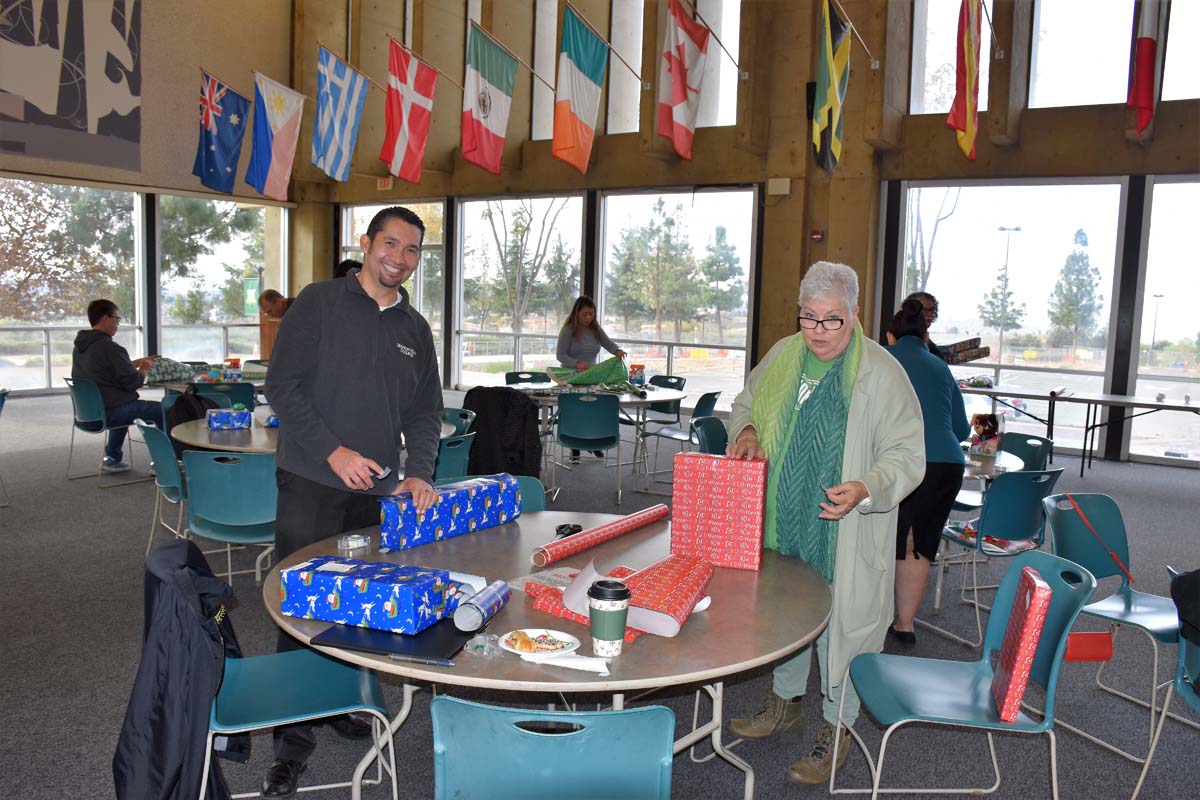 People enjoying the Holiday Wrap Party