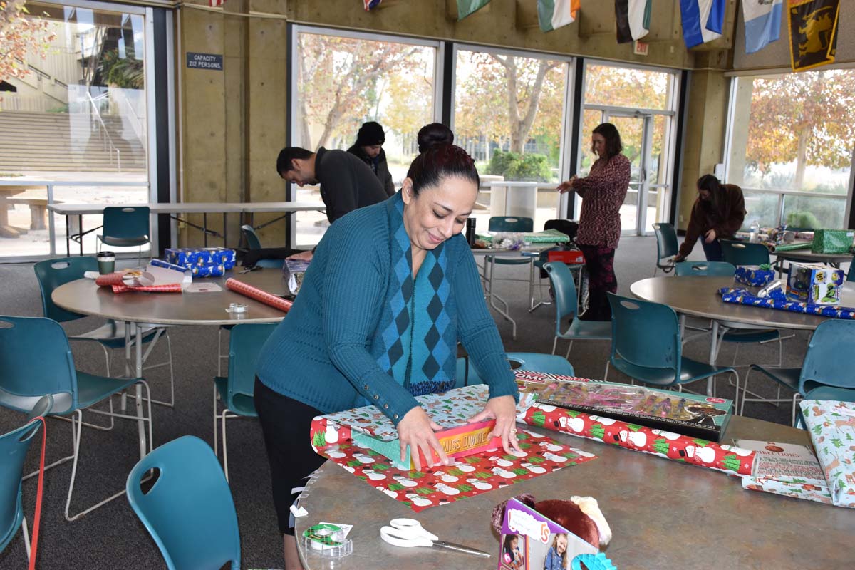 People enjoying the Holiday Wrap Party