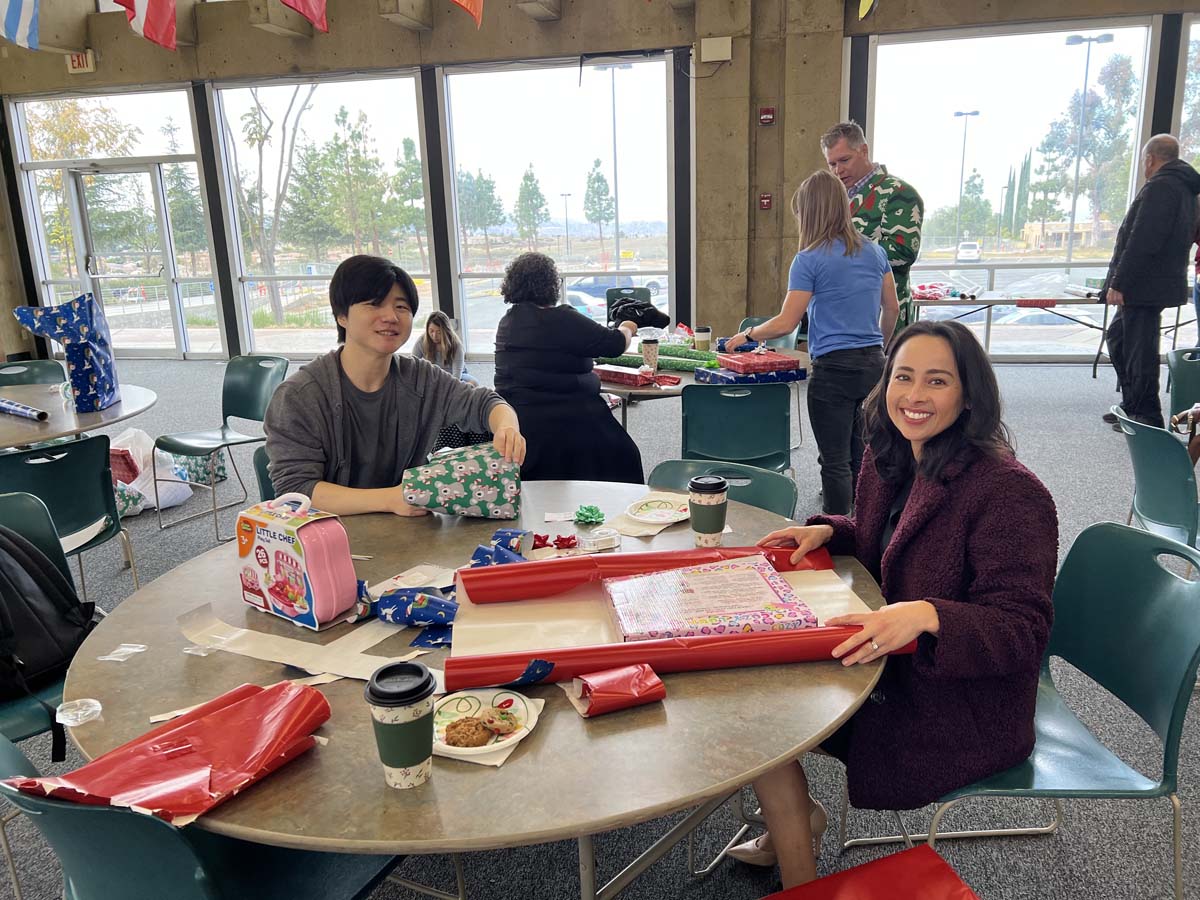 People enjoying the Holiday Wrap Party