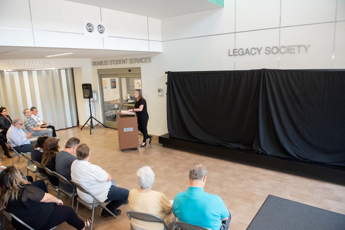 This is a sample image caption.People enjoying the Legacy Wall unveiling