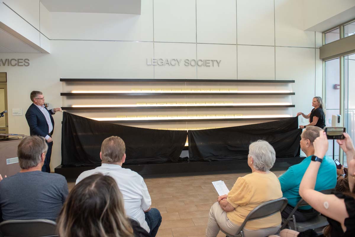 This is a sample image caption.People enjoying the Legacy Wall unveiling