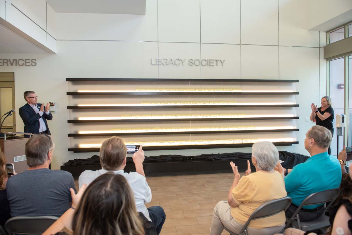 This is a sample image caption.People enjoying the Legacy Wall unveiling