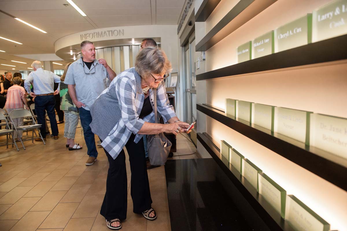 This is a sample image caption.People enjoying the Legacy Wall unveiling