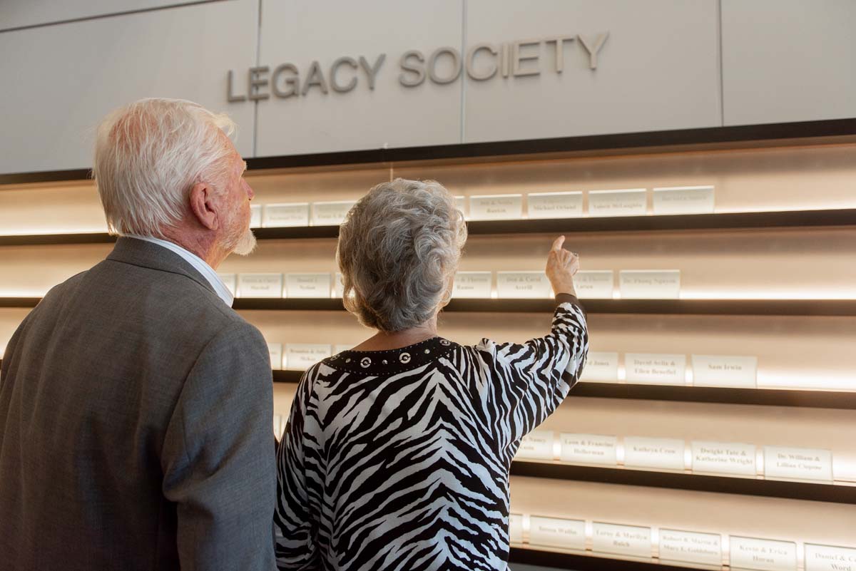 This is a sample image caption.People enjoying the Legacy Wall unveiling