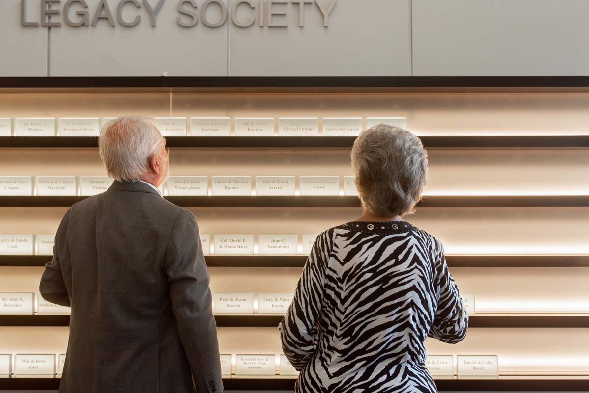 This is a sample image caption.People enjoying the Legacy Wall unveiling