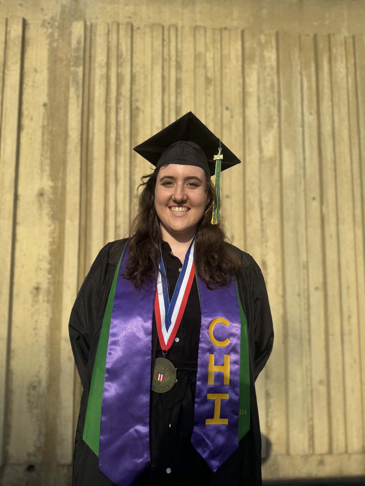Graduates walk to stage at CHC's Commencement 2024.