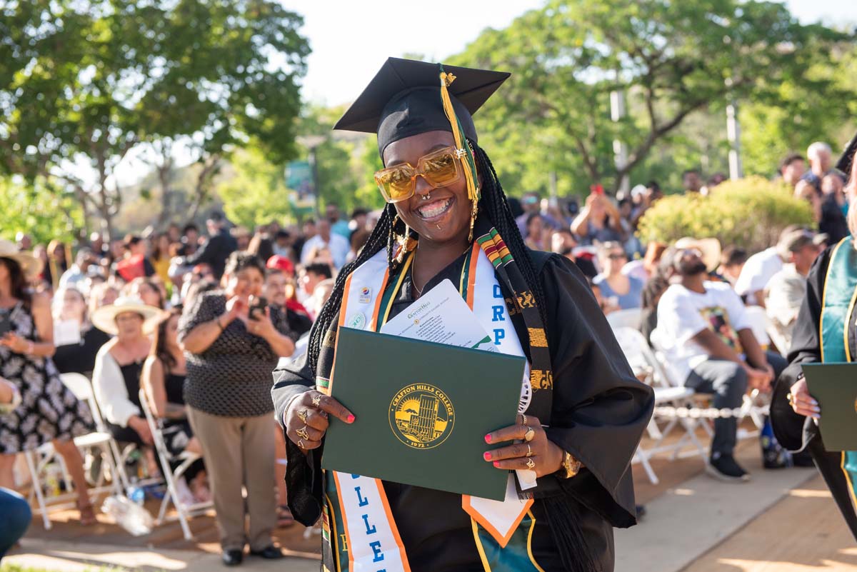 Students receive diploma covers at CHC Commencement 2025.