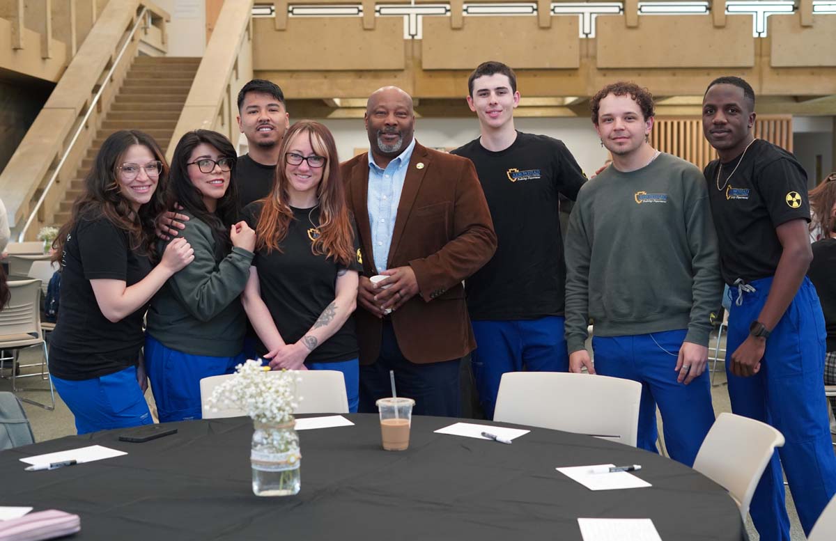 Group of stuents posting with a dean