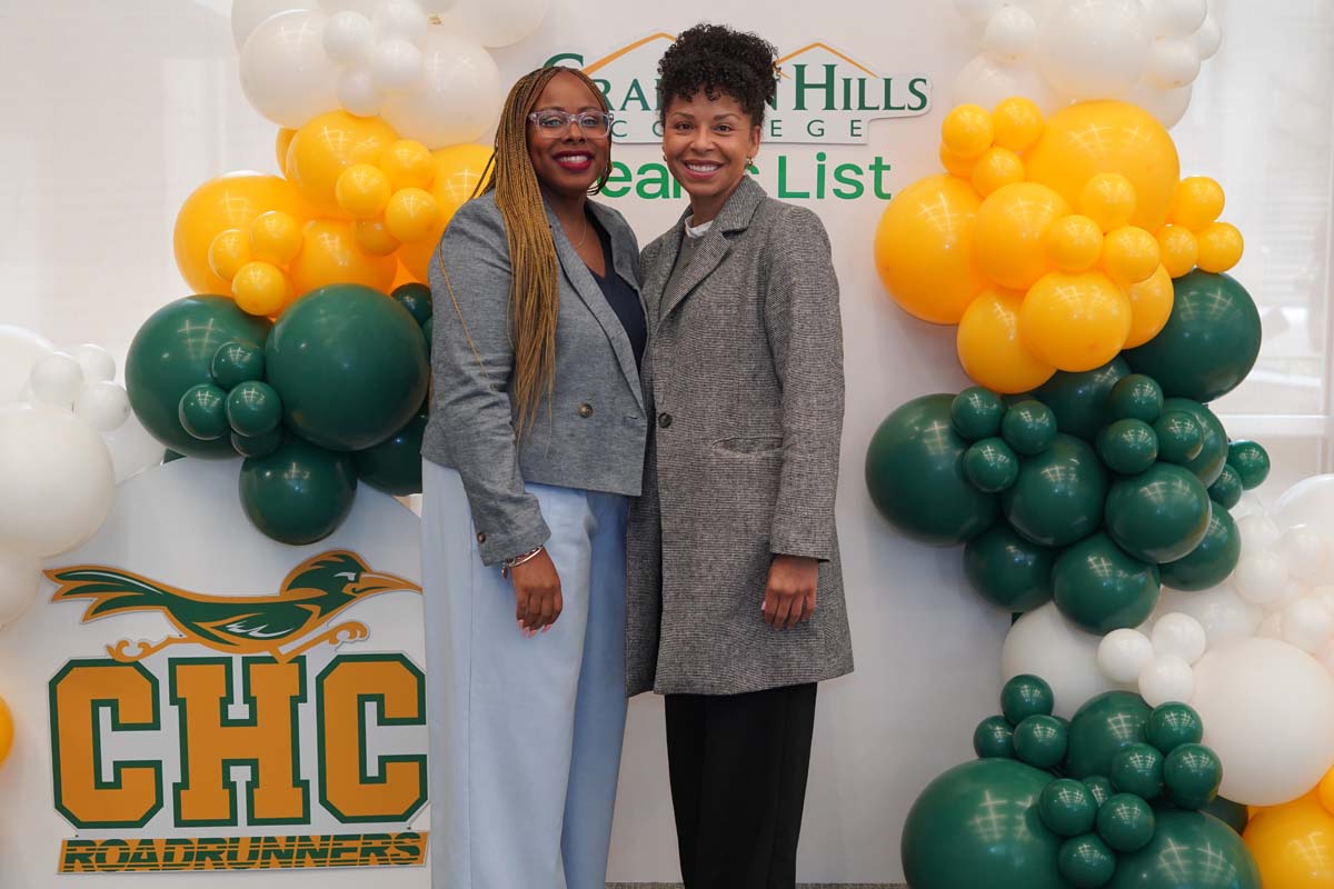Two people in front of backdrop