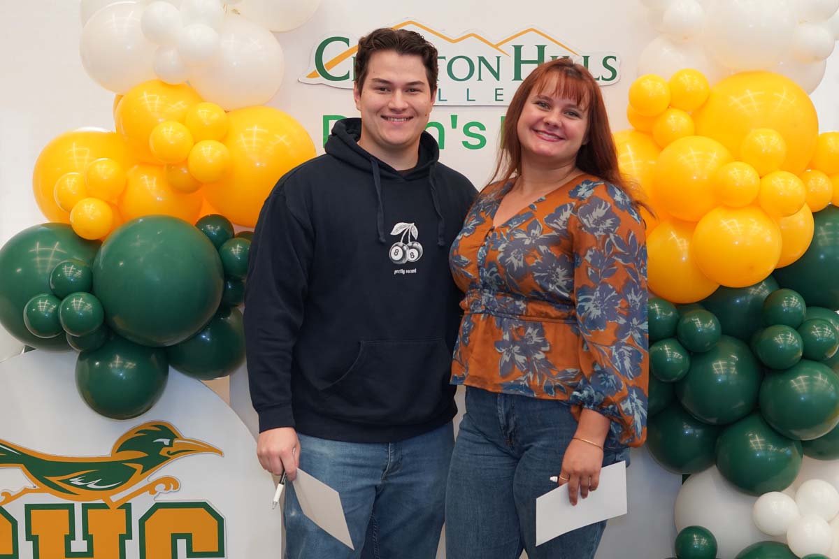 Two people in front of backdrop