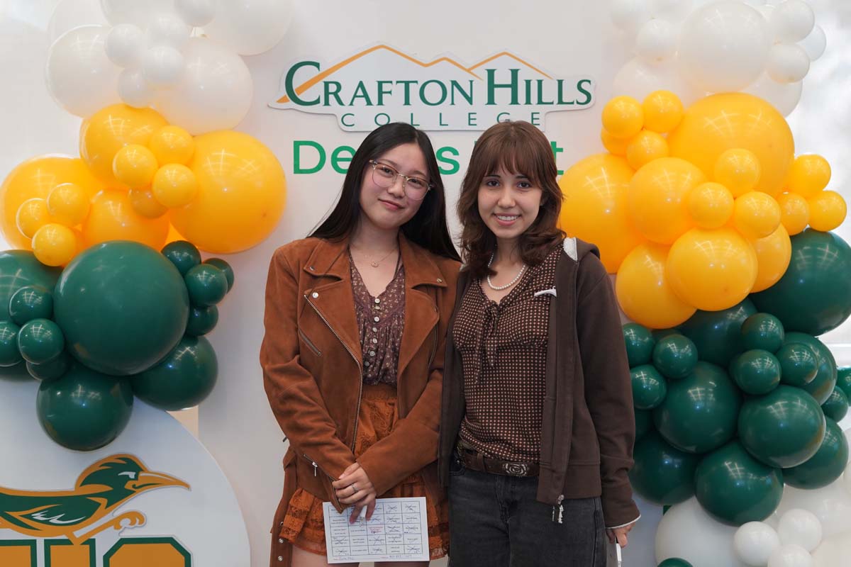 Two people in front of backdrop