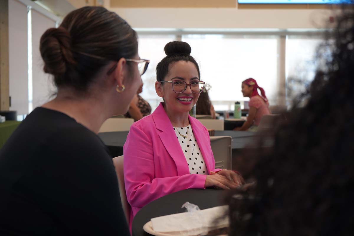 Two people talking to the guest speaker