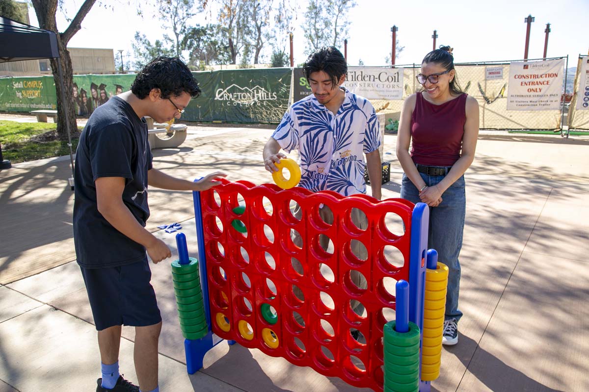 Three students playing game at Thrive Fest