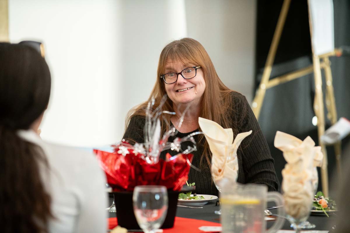 President's Circle Magic Night person at table