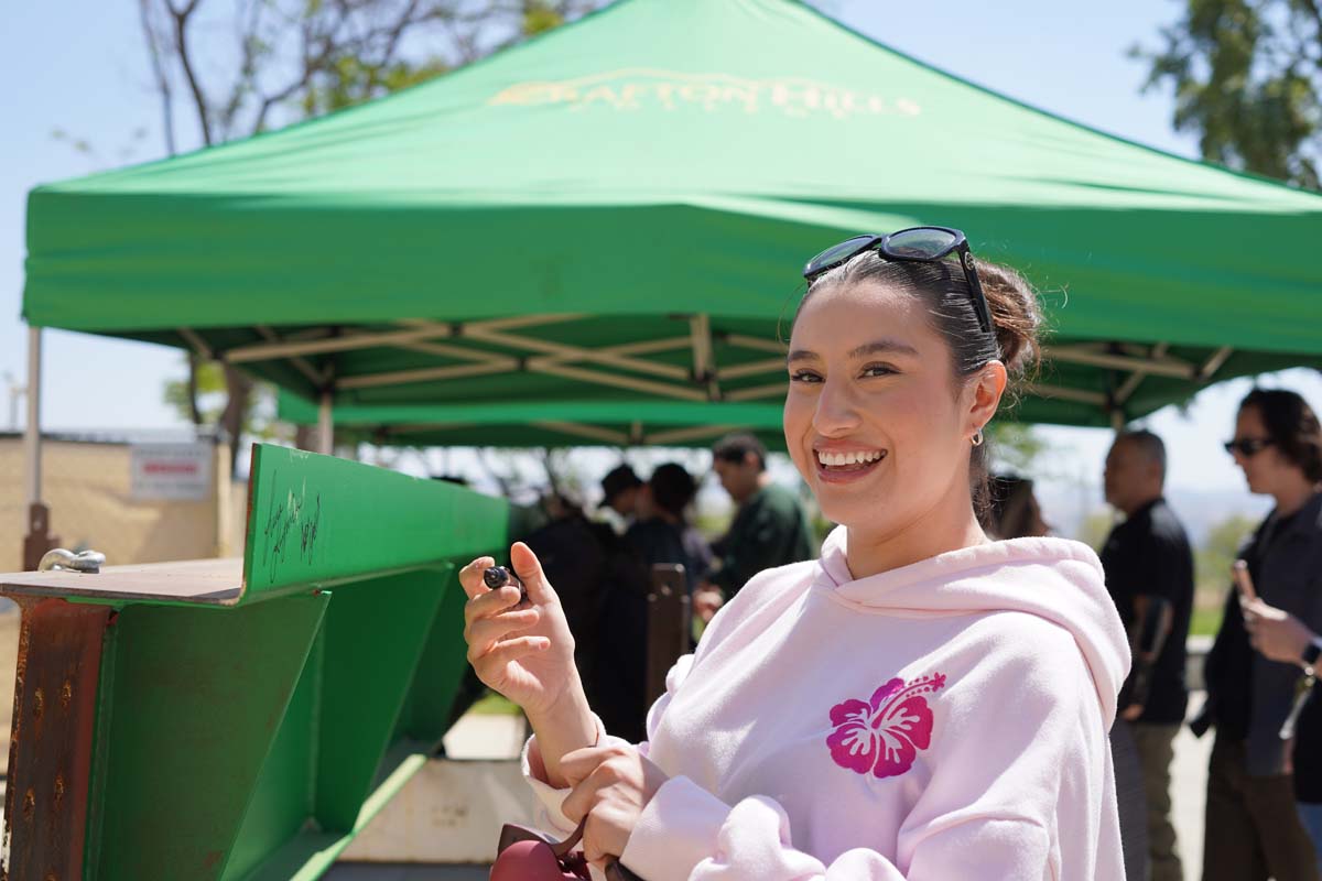 Student signing the beam