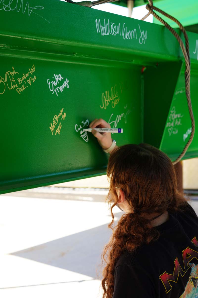 Student signing the beam