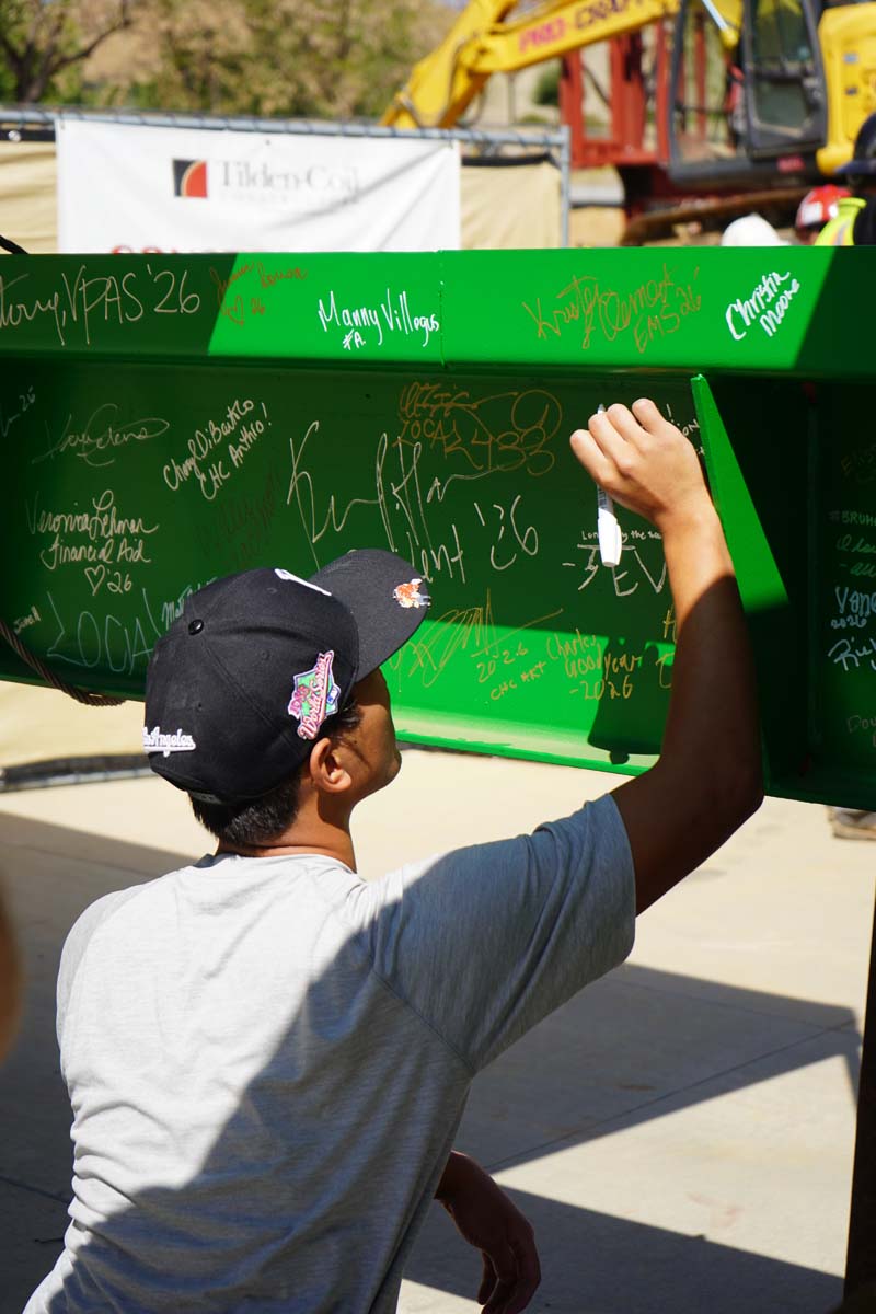 Student signing the beam