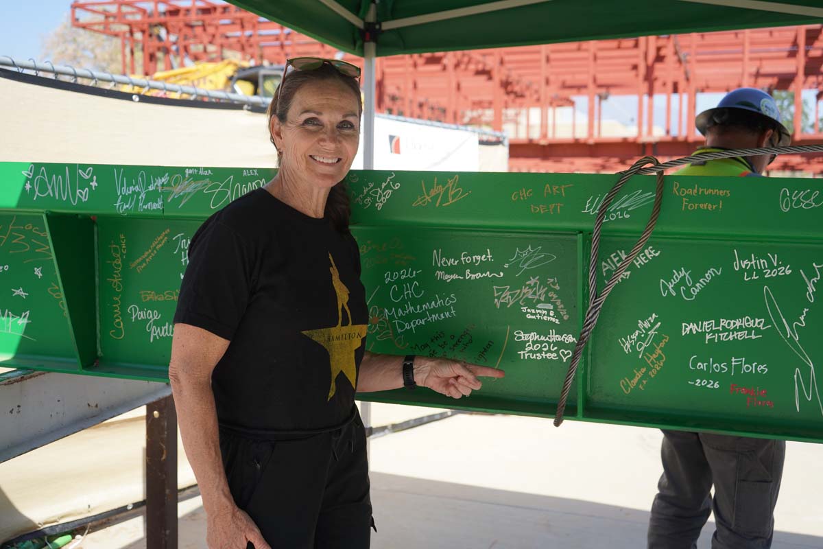 Student posing in front of the beam