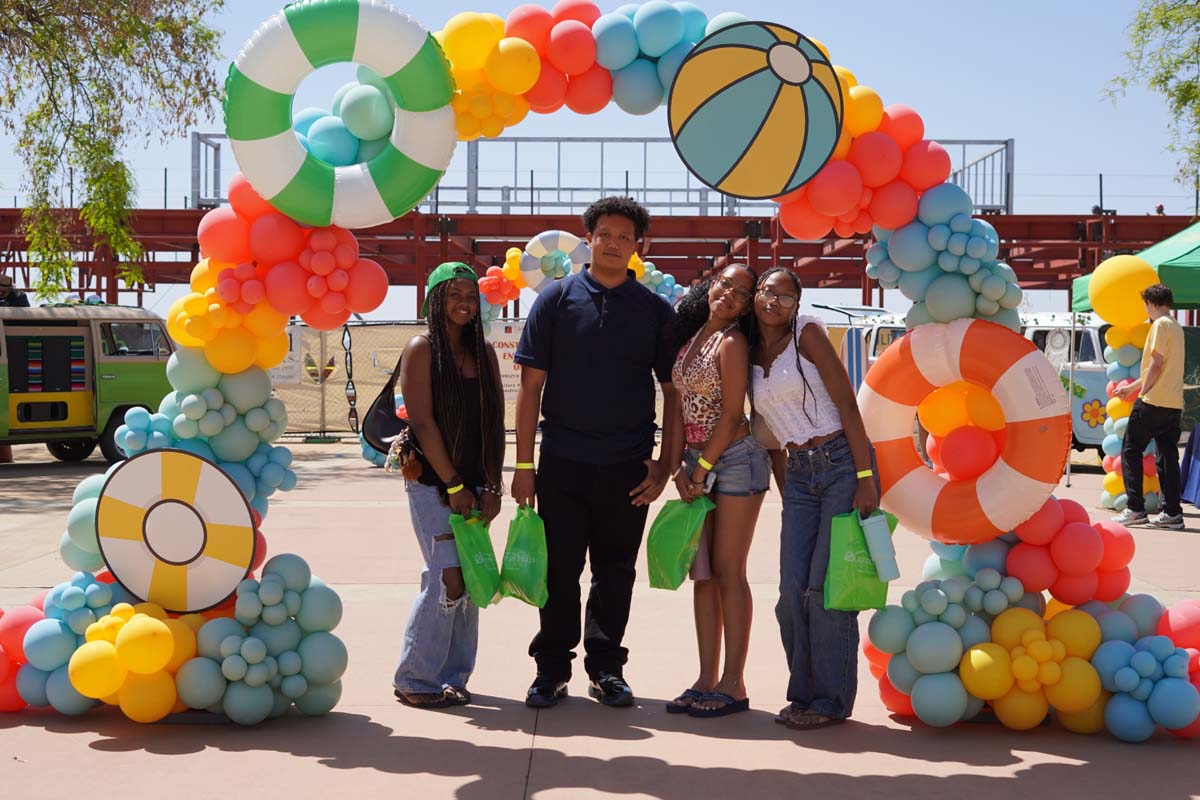 Senior day students in front of the balloon arch