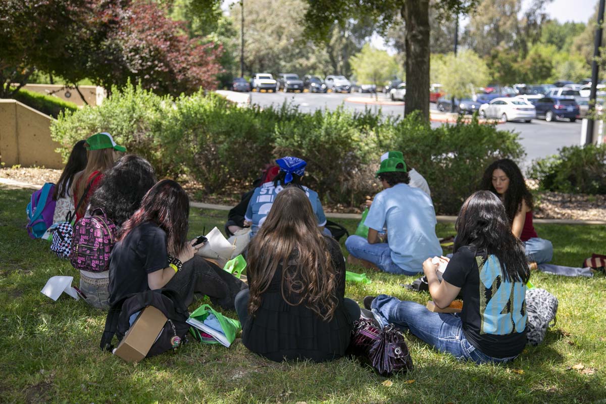 Students eating and waiting for their bus