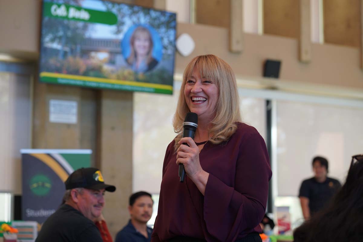 Woman welcoming guests on microphone